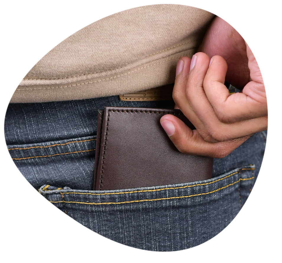 A close up of a man pulling out a his wallet from his back pocket.