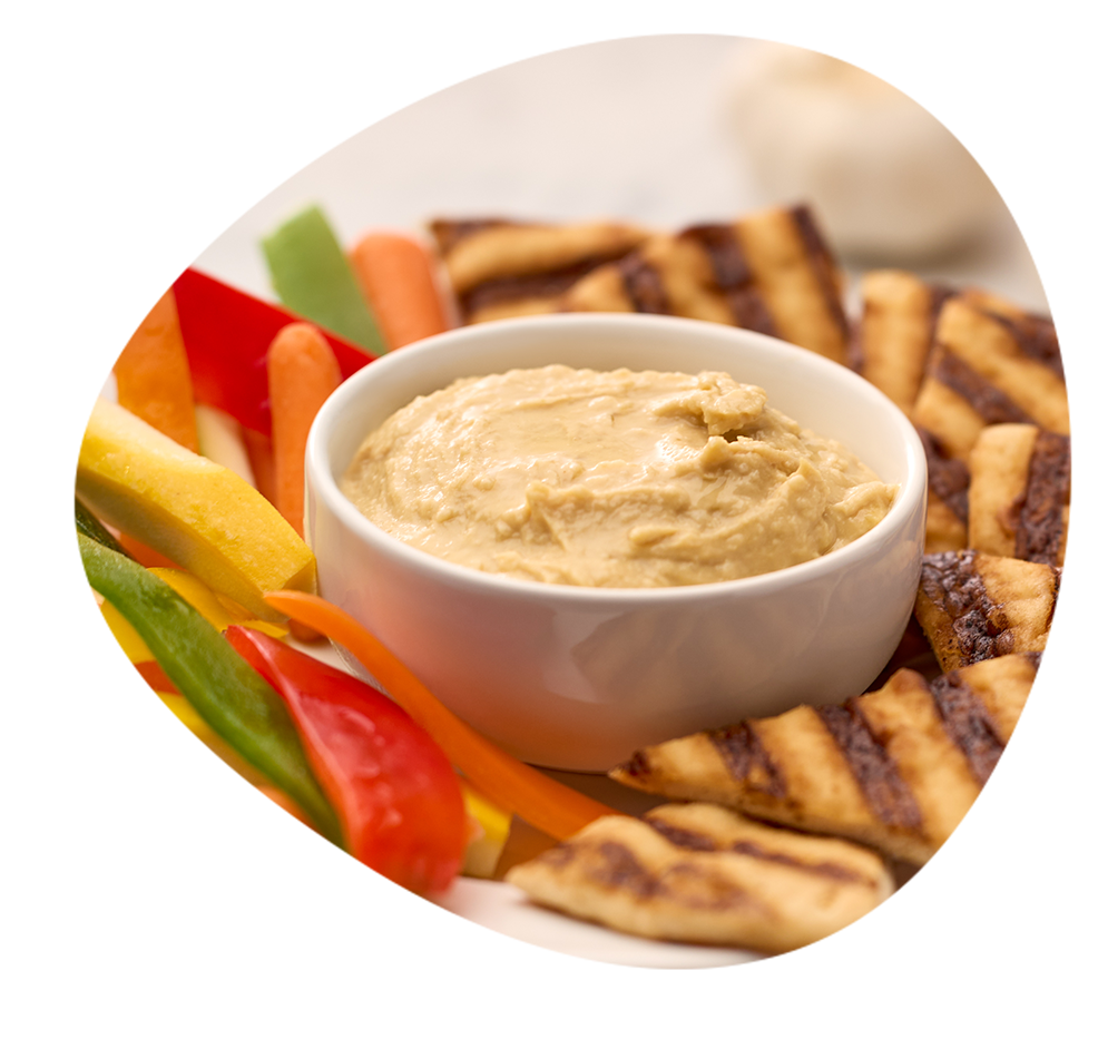 A close up photo of humus on a serving tray.