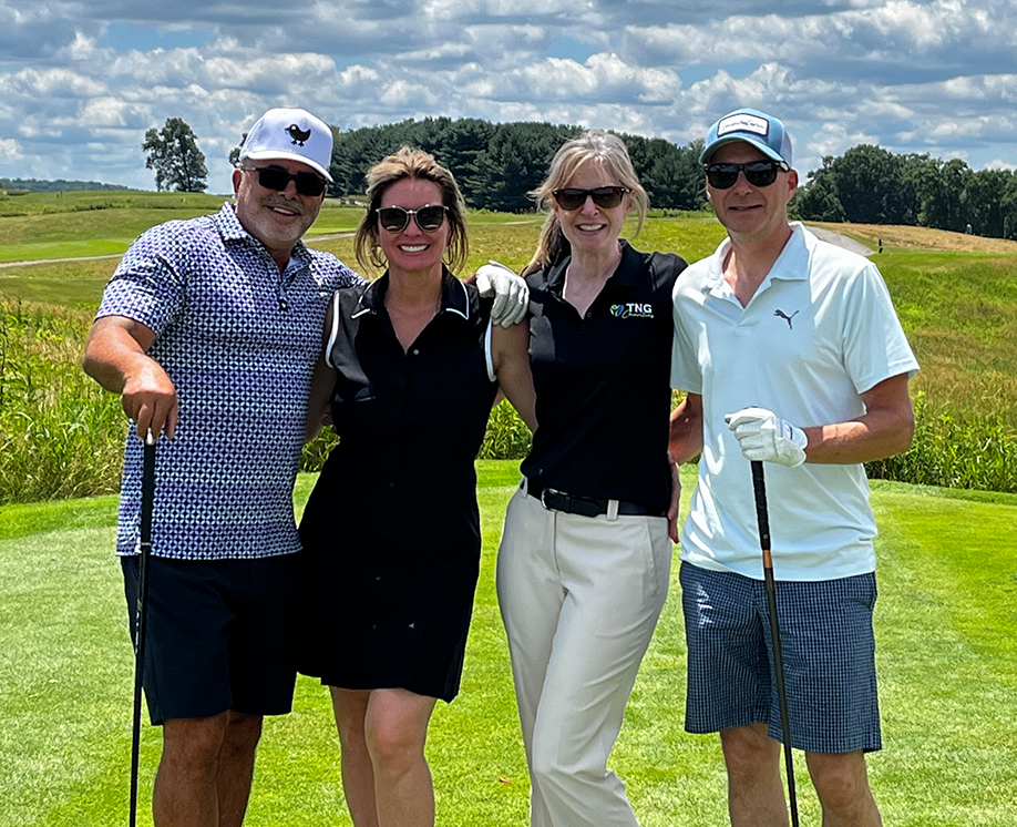 The Nutrition Group management in a group photo at a golf course.