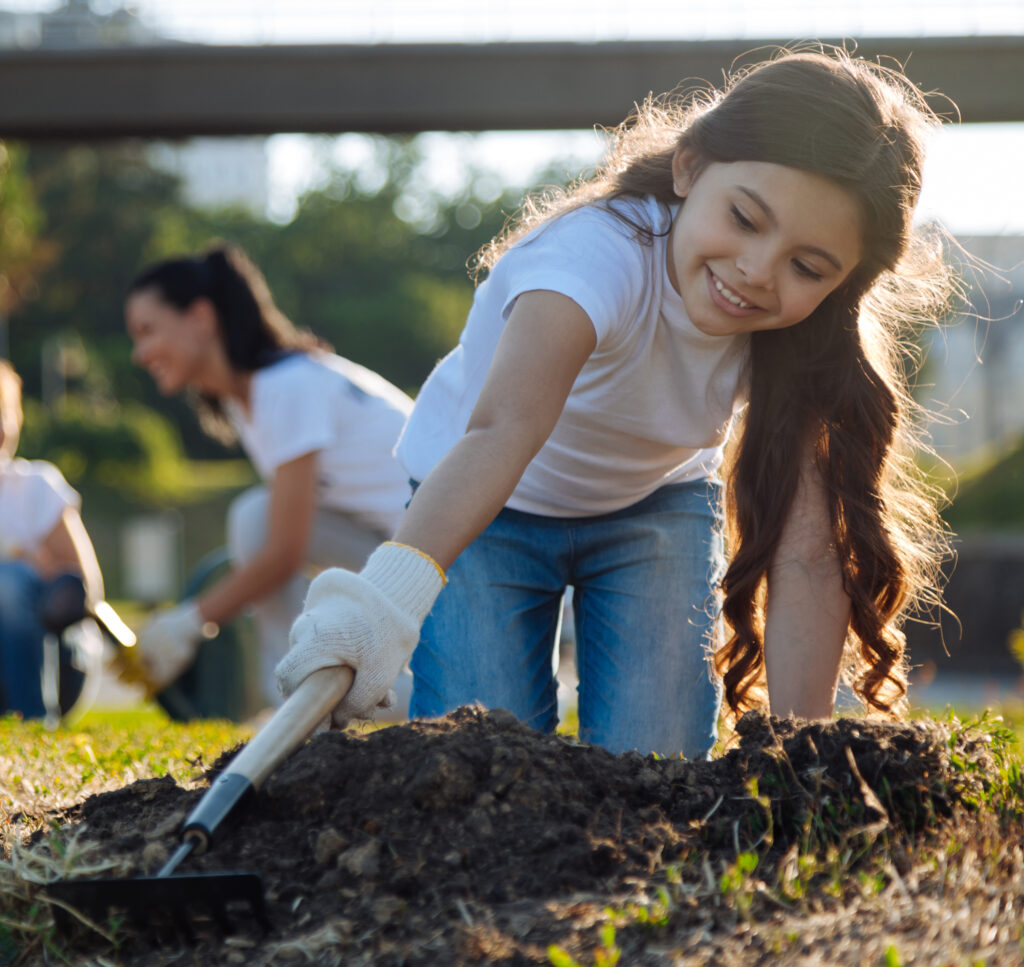 A young girl working in a community garden.